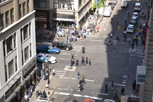 Police stand over the suspect at West 37th Street and 8th Avenue (Courtesy of Gothamist reader Pat)